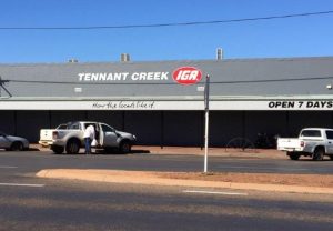 A large building with grey roof and a sign readnig Tennant Creek IGA.
