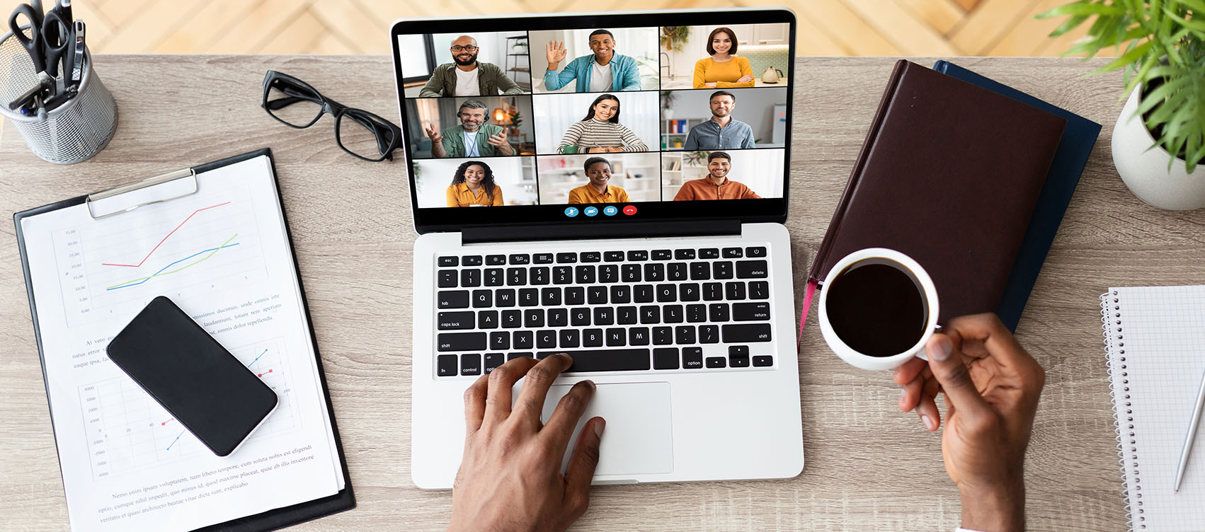 A laptop showing an image of an online meeting.