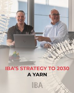 Two men in front of a laptop laughing